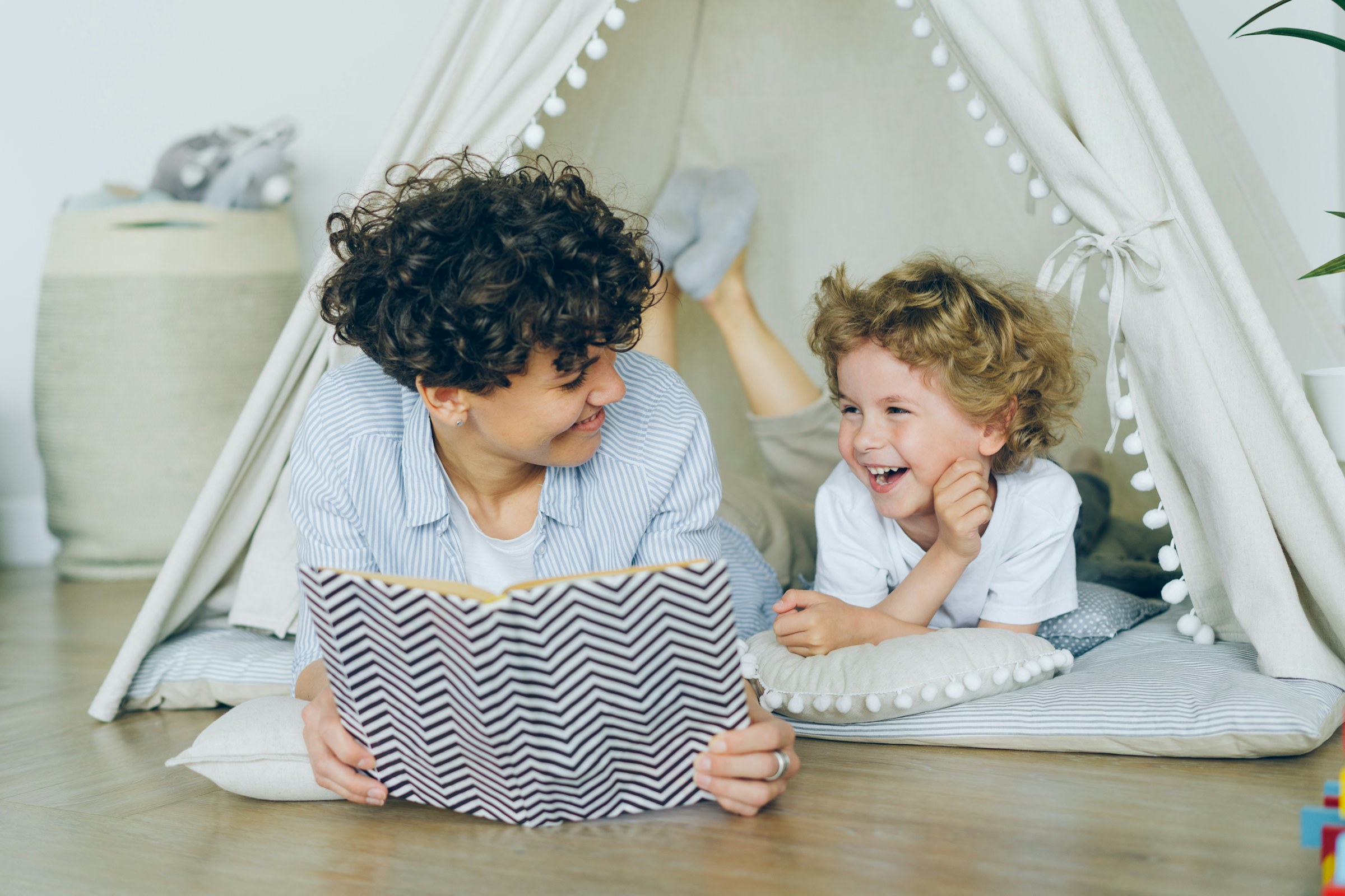 A grown-up reading a book aloud to a child